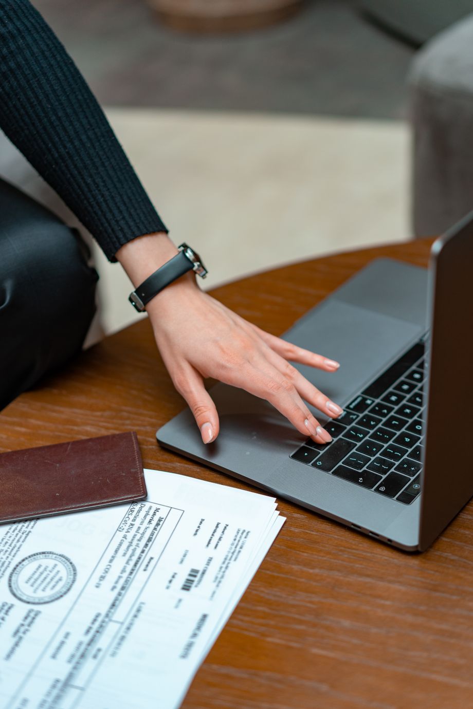 Close-up of hands on a keyboard beside a printed authorization form in a working back office.